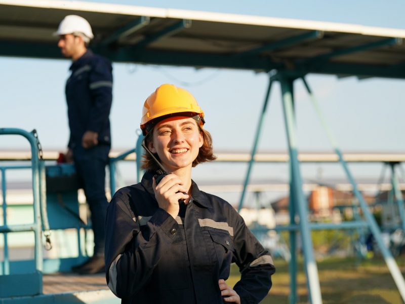 engineers-installing-solar-panels-on-roof-male-engineers-walking-along-rows-of-photovoltaic-panels.jpg